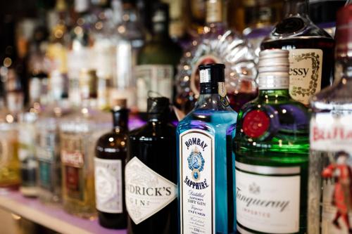 a group of bottles of alcohol sitting on a shelf at Aparthotel Dorfplatzl Garni in Tux