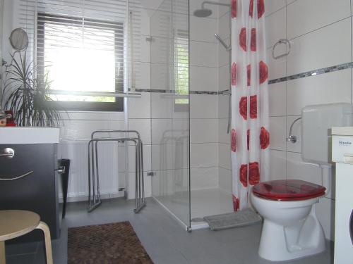 uma casa de banho com um WC e um chuveiro em Ferienwohnung Rosentraum em Oberotterbach