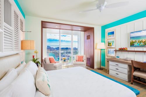 a bedroom with a large white bed and a desk at Margaritaville Hollywood Beach Resort in Hollywood