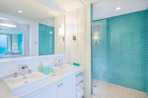 a bathroom with two sinks and a glass shower at Margaritaville Hollywood Beach Resort in Hollywood