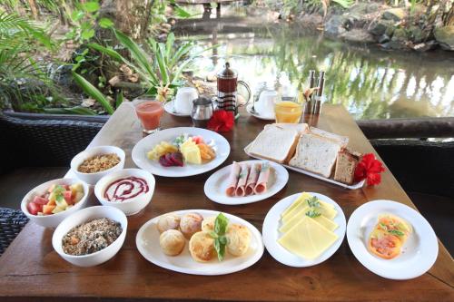 a wooden table with plates of food on it at Pacific Resort Rarotonga in Rarotonga