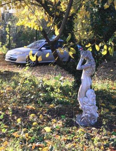 a statue of a squirrel standing in front of a car at 116 Espigarie in Le Vigan