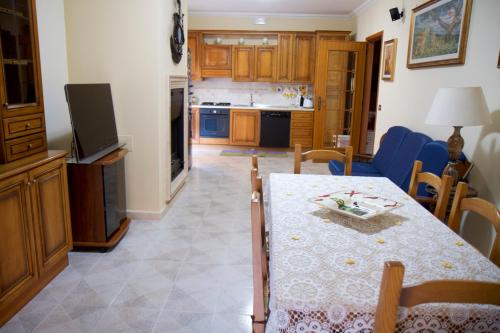 a kitchen and dining room with a table and chairs at Domus Palombi in Ladispoli
