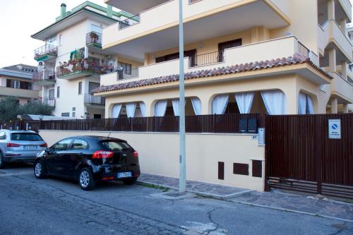 a black car parked in front of a building at Domus Palombi in Ladispoli