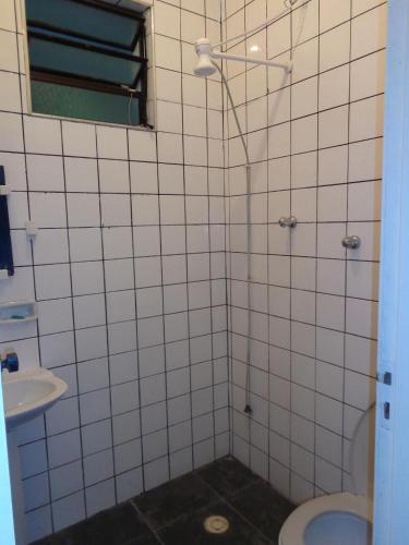 a bathroom with a shower with a toilet and a sink at Casa 2 quartos in Maresias