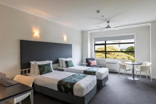 a hotel room with two beds and a window at Quest Napier Serviced Apartments in Napier