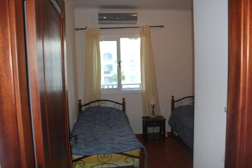 Ліжко або ліжка в номері Alcudia Smir 3 chambres