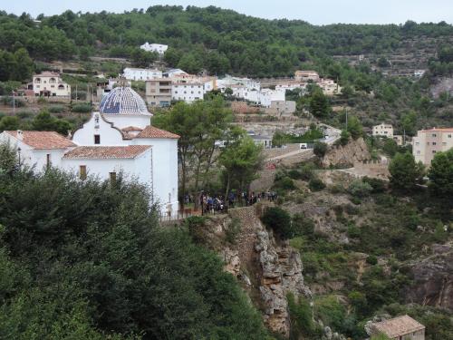a small white building on a hill with buildings at Casa Elina Lucena in Lucena del Cid