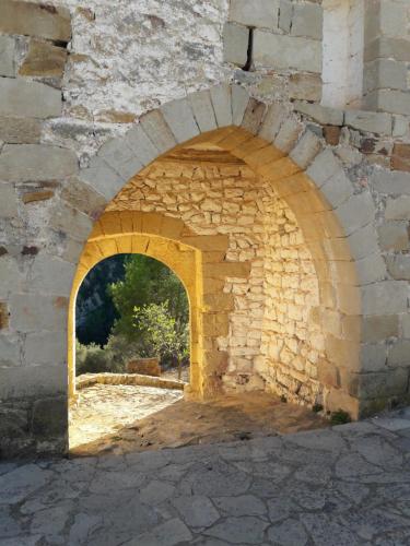 an arch in a stone wall with a window at Casa Elina Lucena in Lucena del Cid