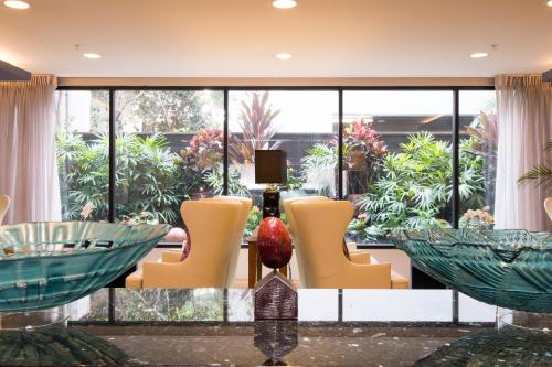 a lobby with chairs and a large window at VIVE Hotel Waikiki in Honolulu