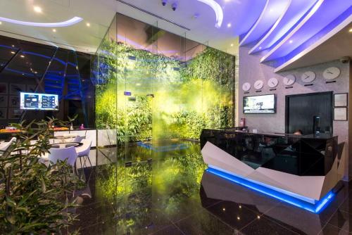 a lobby with a green wall with plants at Arton Boutique Hotel in Singapore