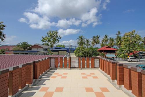 a brick wall with a gate and a parking lot at Myvilla Langkawi Hotel in Pantai Cenang