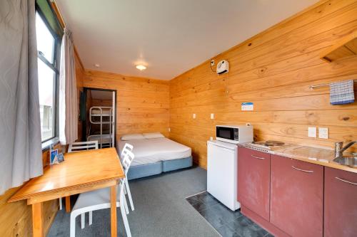a small room with a kitchen and a bed at Wellington TOP 10 Holiday Park in Lower Hutt