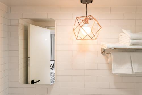 a bathroom with a mirror and a light fixture at Neat House in Seoul