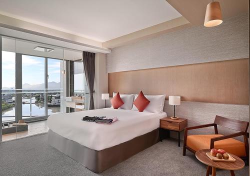a hotel room with a large bed and a balcony at Dancewoods Hotel in Wujie