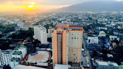 an aerial view of a city with a tall building at Duangtawan Hotel Chiang Mai in Chiang Mai