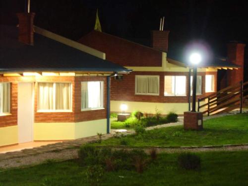 a house with a street light in front of it at Complejo Don Osvaldo in Sierra de la Ventana