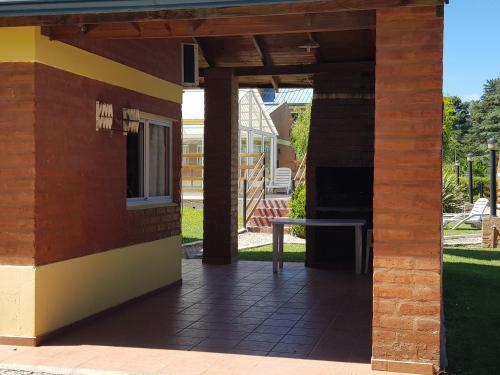 a patio of a house with a table at Complejo Don Osvaldo in Sierra de la Ventana