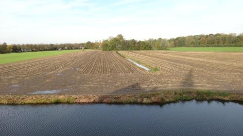 an aerial view of a field and a body of water at Het Wapen van Harmelen in Harmelen