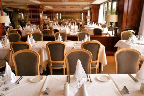 a dining room with white tables and chairs at Hotel Vallemar in Puerto de la Cruz
