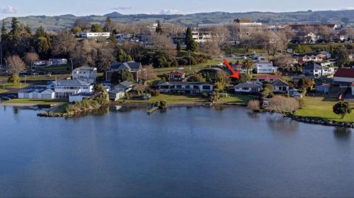 an aerial view of a town with a large lake at Lakefront Getaway in Rotorua in Rotorua