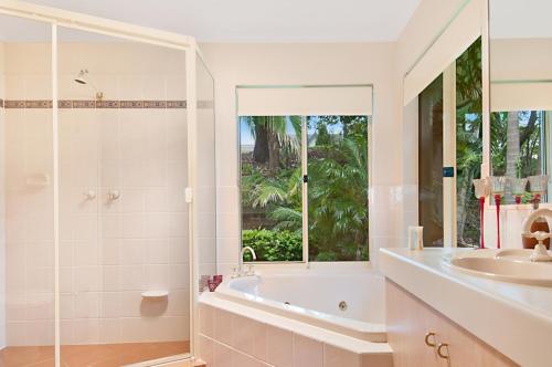 a bathroom with a tub and a sink at Casa Al Lago in Montville