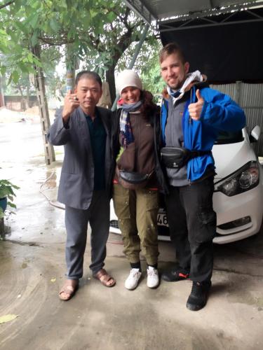 a group of three people standing in front of a car at Thanh Thúy Guesthouse in Ðông Hà