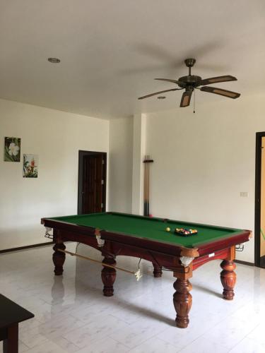 a pool table in a room with a ceiling at Sleep Soundly By The Sea in Trat