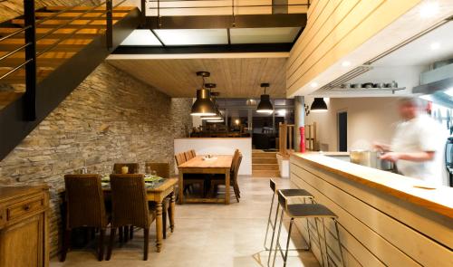 a kitchen and dining room with a chef preparing food at Il était une fois in Herbeumont