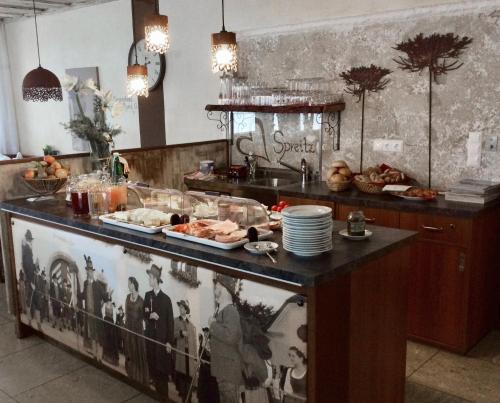 a kitchen with a counter with food on it at Pension Spreitzhof & Appartement Royer in Schladming