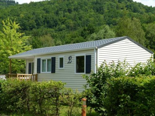 a white house with the number on it at Camping Base de Loisirs du Lac de la Moselotte in Saulxures-sur-Moselotte
