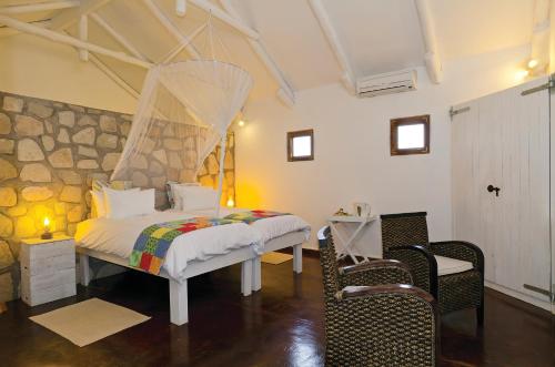 a bedroom with a bed with a net at Gondwana Kalahari Farmhouse in Stampriet