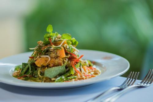 a white plate of food on a table at Khemara Angkor Hotel & Spa in Siem Reap