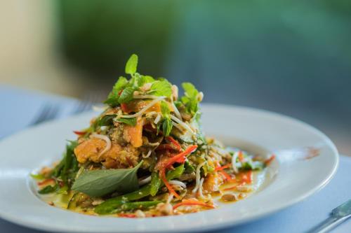 a white plate of food on a table at Khemara Angkor Hotel & Spa in Siem Reap