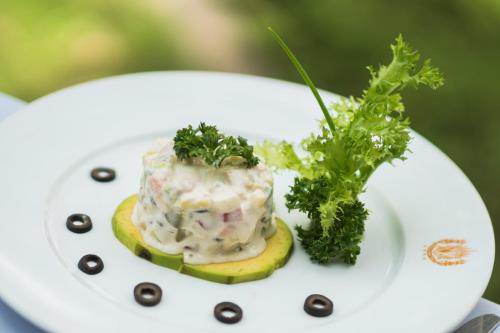 a white plate with a dessert on top at Khemara Angkor Hotel & Spa in Siem Reap