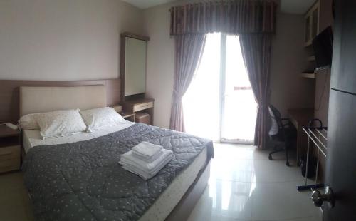 Ένα ή περισσότερα κρεβάτια σε δωμάτιο στο Jakarta Residence