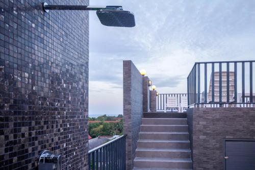 a stairway leading up to a building with a building at Baan Nilrath Hotel - SHA Extra Plus in Hua Hin