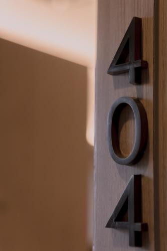 a close up of a wooden number on a wall at Maxim's Inn in Bangkok
