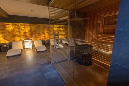 a lobby with chairs and a fireplace in a building at Willa Skałka in Białka Tatrzanska