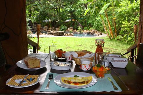 a table with plates of food on top of it at Kaia Tani Exclusive Guesthouse in Phalaborwa
