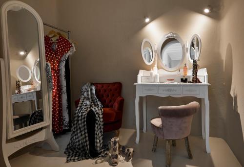 a dressing room with a vanity and mirrors at Carpe Diem Santorini in Pirgos
