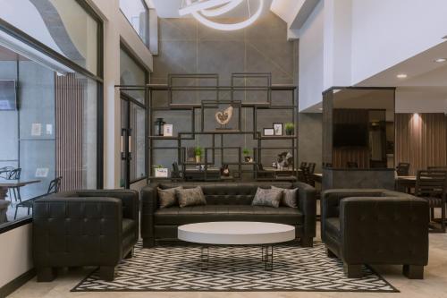 a living room with a couch and a table at Maxim's Inn in Bangkok