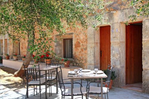 a table and chairs sitting in front of a building at Finca Son Guardiola in Llucmajor