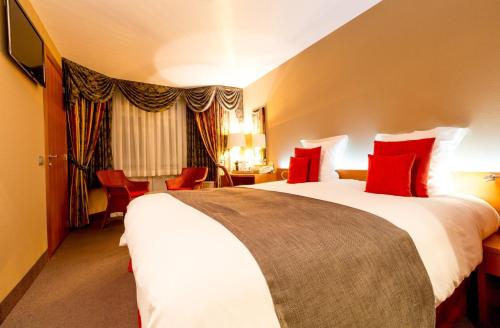 Een bed of bedden in een kamer bij Hotel Royal