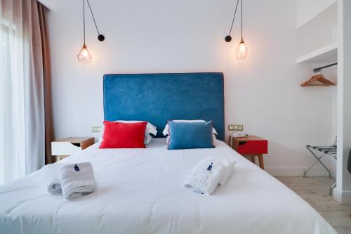 a bedroom with a large white bed with two pillows at White Bottle Superior Apartments in Thessaloniki