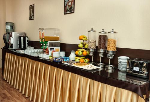 a buffet in a hotel room with food on a counter at Hotel Magnus Galati in Galaţi