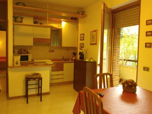 a kitchen and dining room with a table and a kitchen at Freetime in Perugia