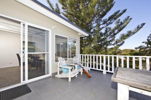 A balcony or terrace at Shells on the Shore Holiday Accomm - Possums