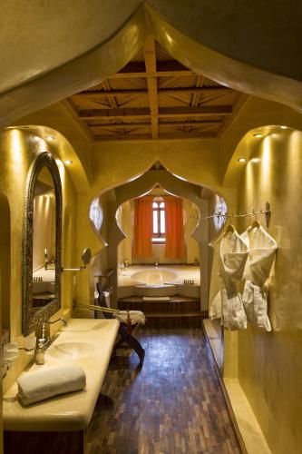 a bathroom with a large sink and a tub at Riad Chbanate in Essaouira