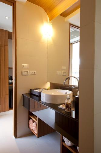 a bathroom with a sink and a mirror at G Hua Hin Resort & Mall in Hua Hin